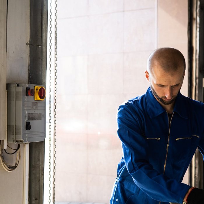 Electrician and business owner at a panel